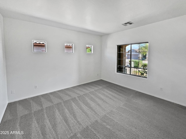 8616 S 57th Dr, Laveen, AZ 85339 - spare room with dark carpet, visible vents, and baseboards