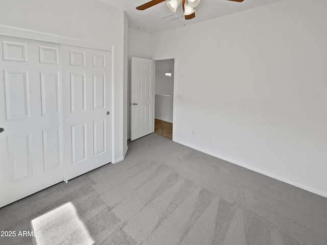 8616 S 57th Dr, Laveen, AZ 85339 - unfurnished bedroom featuring a closet, baseboards, a ceiling fan, and carpet floors