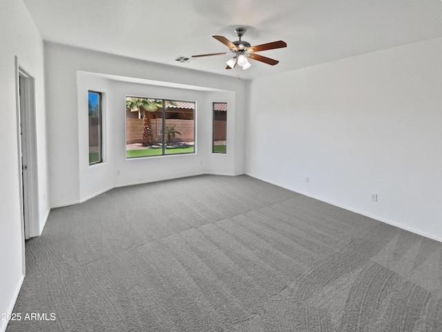 8616 S 57th Dr, Laveen, AZ 85339 - spare room featuring visible vents, ceiling fan, and dark colored carpet