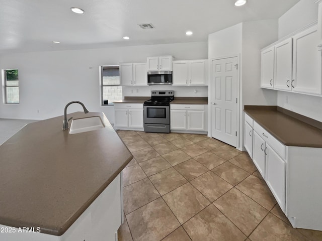 8616 S 57th Dr, Laveen, AZ 85339 - kitchen with visible vents, recessed lighting, dark countertops, a sink, and stainless steel appliances