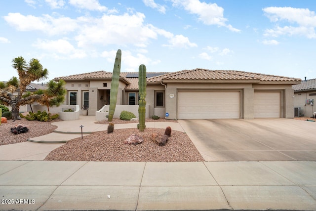 20017 N Cielo Ct, Surprise, AZ 85374 - mediterranean / spanish-style house featuring concrete driveway, stucco siding, an attached garage, solar panels, and a tiled roof