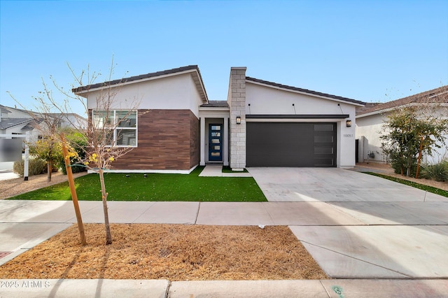 view of front facade featuring a garage and a front lawn