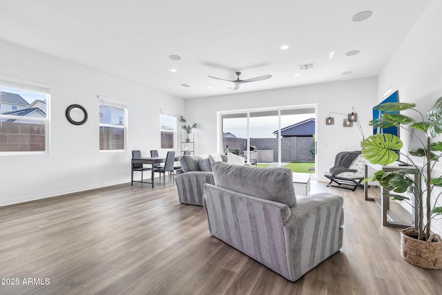 living room featuring wood-type flooring, a wealth of natural light, and ceiling fan