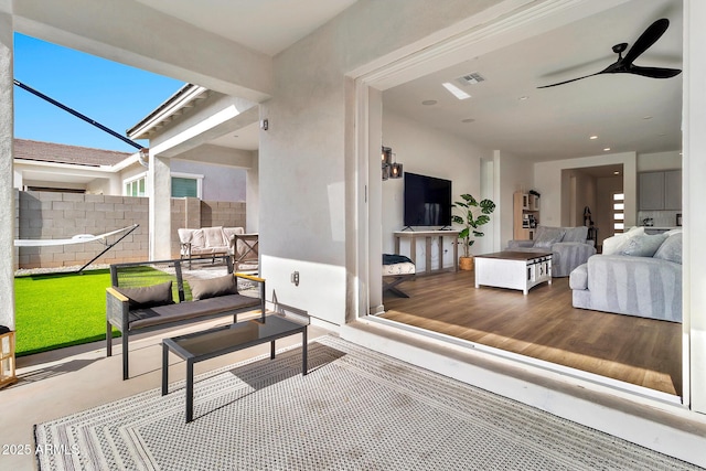 interior space with hardwood / wood-style floors and ceiling fan