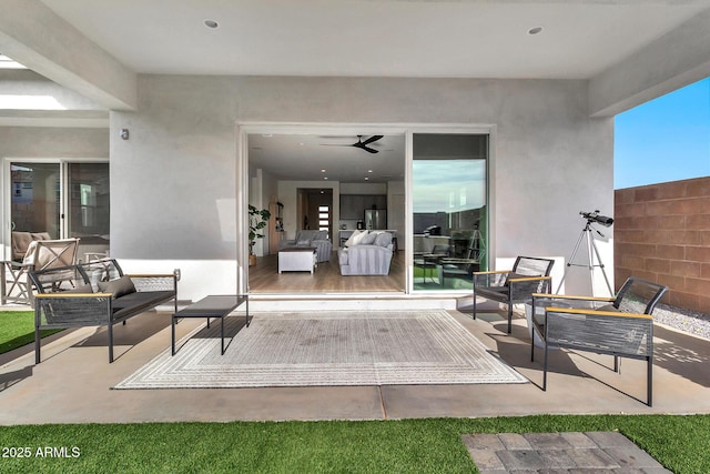 view of patio featuring an outdoor living space and ceiling fan