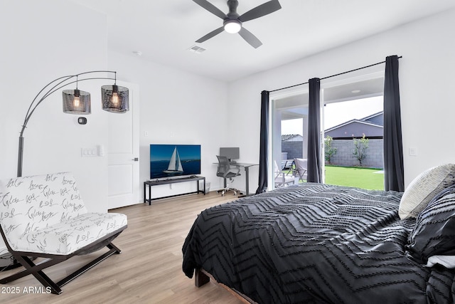 bedroom with light hardwood / wood-style flooring, ceiling fan, and access to outside