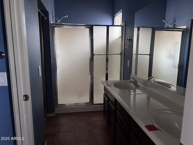 bathroom with tile patterned floors, vanity, and a shower with shower door