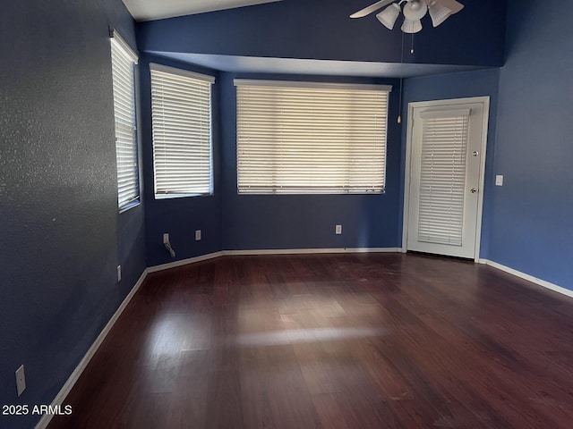 unfurnished room with hardwood / wood-style flooring, ceiling fan, and vaulted ceiling