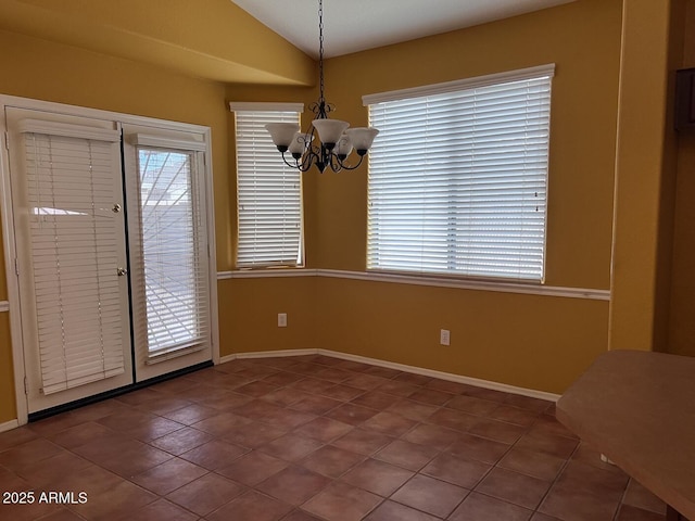 unfurnished dining area with tile patterned floors, lofted ceiling, and an inviting chandelier