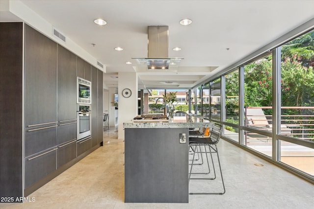kitchen featuring plenty of natural light, modern cabinets, stainless steel appliances, and visible vents