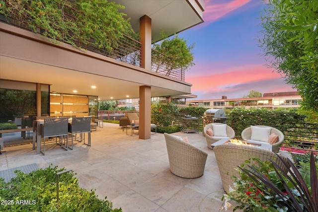 patio terrace at dusk with outdoor lounge area and outdoor dining area