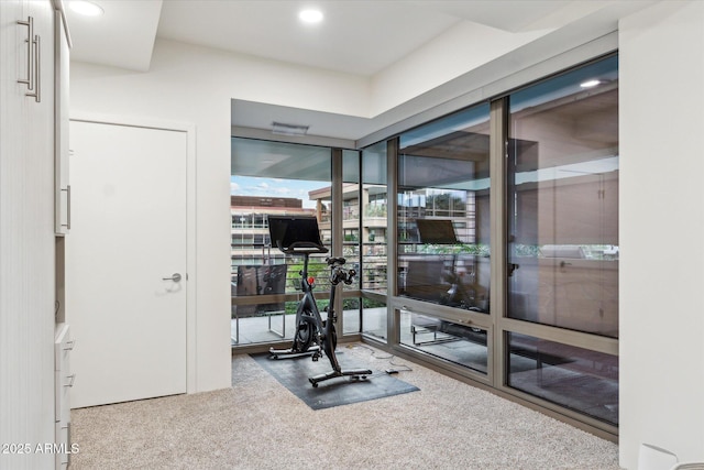 workout room with a wall of windows, carpet flooring, and recessed lighting