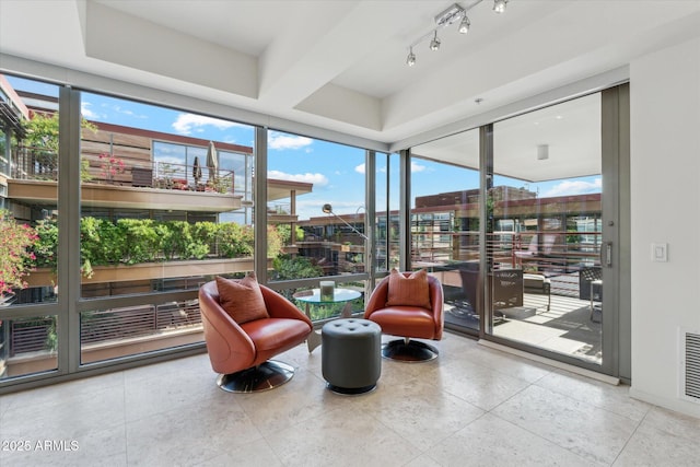 sunroom / solarium featuring floor to ceiling windows