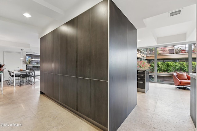 hall with recessed lighting and visible vents