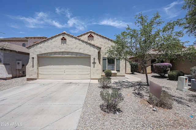 5418 W Carson Rd, Laveen, AZ 85339 - mediterranean / spanish house with an attached garage, driveway, stucco siding, and a tile roof