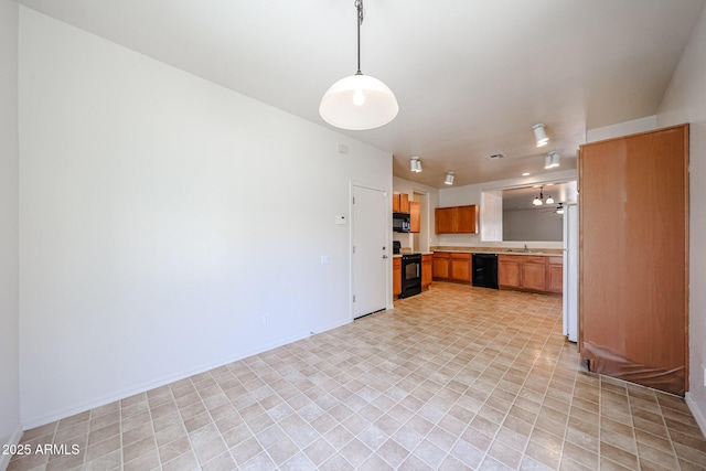5418 W Carson Rd, Laveen, AZ 85339 - kitchen featuring black appliances, light countertops, brown cabinets, decorative light fixtures, and open floor plan