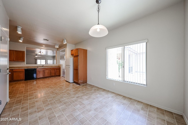 5418 W Carson Rd, Laveen, AZ 85339 - kitchen with black dishwasher, brown cabinetry, freestanding refrigerator, light countertops, and hanging light fixtures