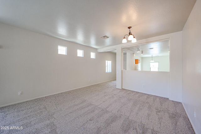 5418 W Carson Rd, Laveen, AZ 85339 - carpeted spare room with a chandelier and baseboards