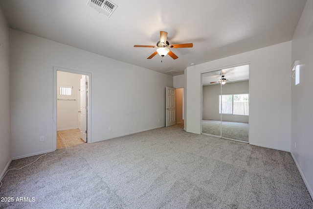 5418 W Carson Rd, Laveen, AZ 85339 - unfurnished bedroom featuring carpet flooring, a closet, connected bathroom, and ceiling fan