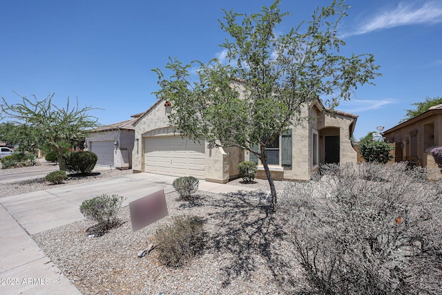 5418 W Carson Rd, Laveen, AZ 85339 - view of front of home with stucco siding, driveway, and a garage