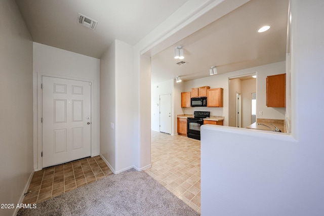 5418 W Carson Rd, Laveen, AZ 85339 - kitchen featuring black appliances, light countertops, recessed lighting, and light carpet