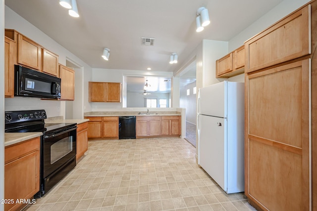 5418 W Carson Rd, Laveen, AZ 85339 - kitchen with black appliances, light countertops, light brown cabinetry, and a peninsula