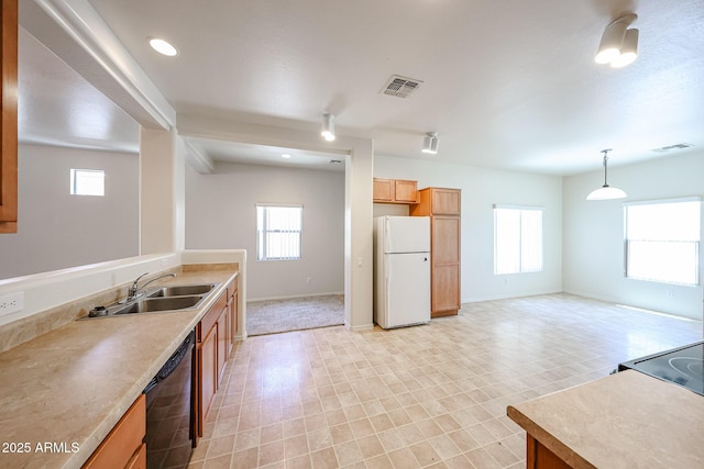 5418 W Carson Rd, Laveen, AZ 85339 - kitchen with freestanding refrigerator, dishwasher, light countertops, decorative light fixtures, and recessed lighting
