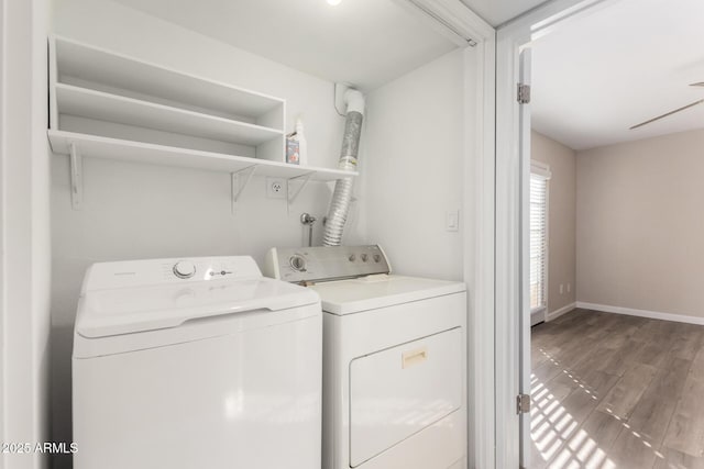 washroom with laundry area, baseboards, washer and dryer, and wood finished floors