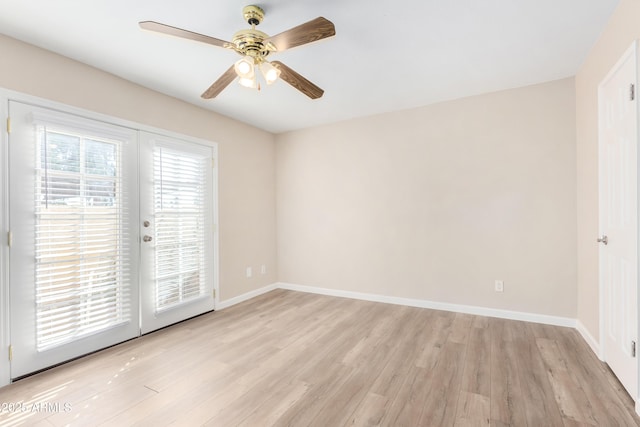 spare room with a ceiling fan, french doors, baseboards, and light wood finished floors