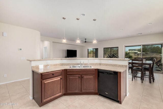 kitchen featuring sink, light tile patterned floors, dishwasher, a center island with sink, and decorative light fixtures