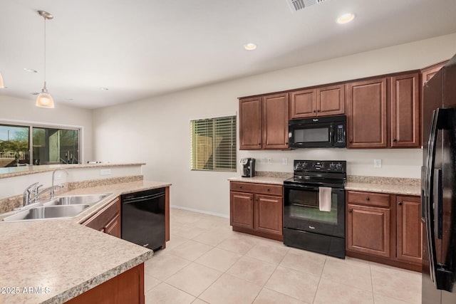 kitchen with light tile patterned floors, decorative light fixtures, sink, and black appliances