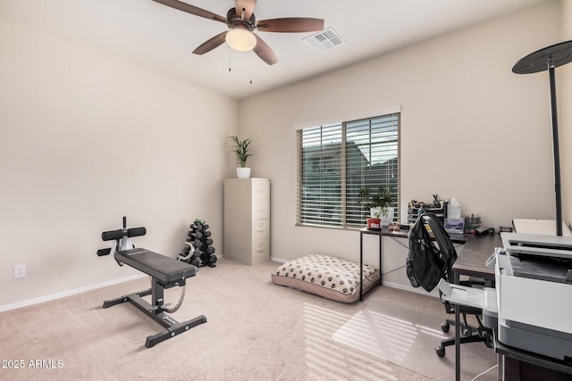 carpeted office featuring ceiling fan