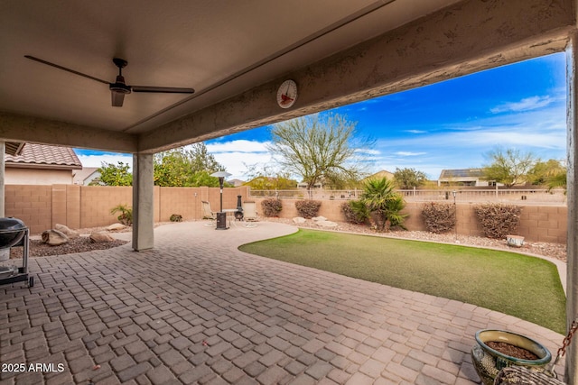 view of patio with a grill and ceiling fan