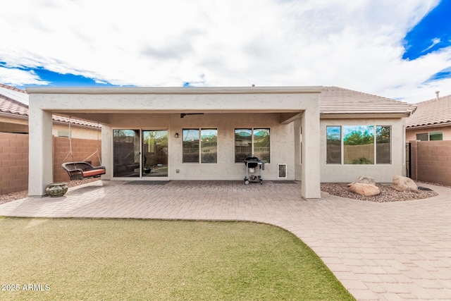 back of property with a patio