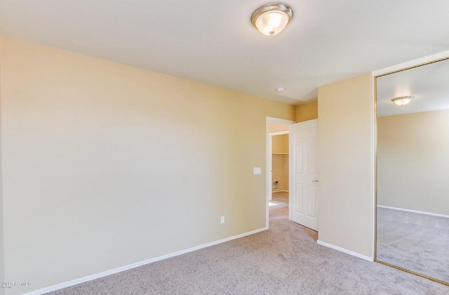 unfurnished bedroom featuring carpet floors, a closet, and baseboards