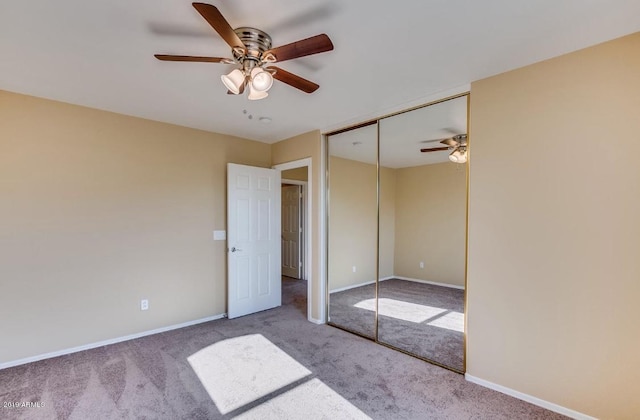 unfurnished bedroom with carpet flooring, ceiling fan, and baseboards