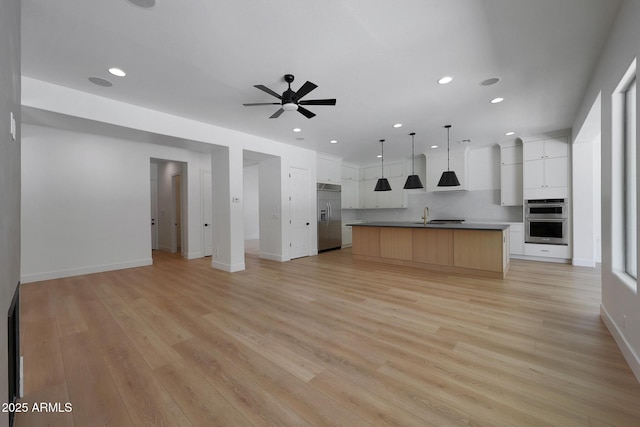 2859 E Los Altos Rd, Gilbert, AZ 85297 - unfurnished living room with a ceiling fan, recessed lighting, and light wood-style floors