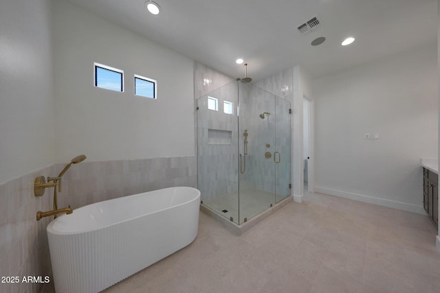 2859 E Los Altos Rd, Gilbert, AZ 85297 - full bathroom featuring a stall shower, a freestanding tub, vanity, recessed lighting, and tile walls
