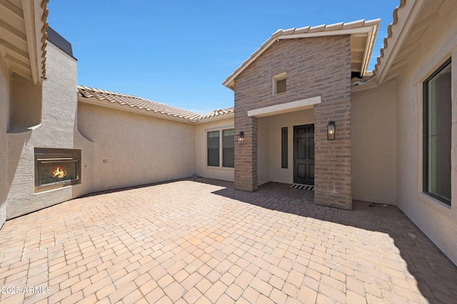 2859 E Los Altos Rd, Gilbert, AZ 85297 - view of patio with a lit fireplace