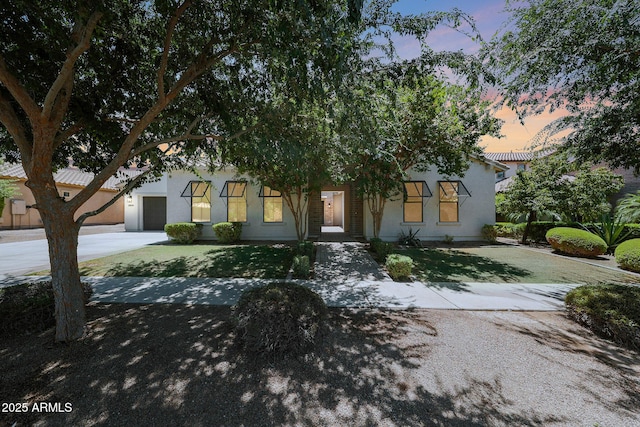 2859 E Los Altos Rd, Gilbert, AZ 85297 - obstructed view of property with concrete driveway, a lawn, stucco siding, and a garage
