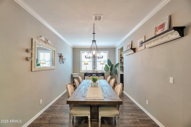 dining area featuring crown molding, dark wood finished floors, visible vents, a chandelier, and baseboards