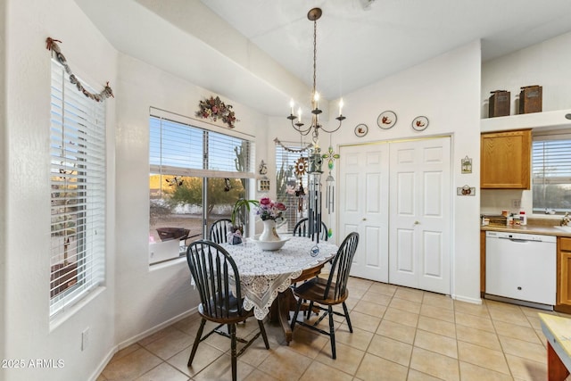 dining room with lofted ceiling, baseboards, an inviting chandelier, and light tile patterned floors