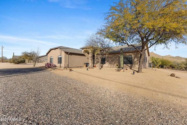 view of front of property with a mountain view and stucco siding