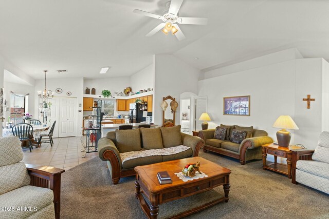 living room with arched walkways, high vaulted ceiling, light tile patterned floors, ceiling fan with notable chandelier, and visible vents