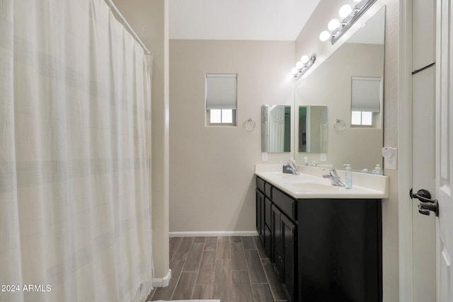 bathroom with vanity and hardwood / wood-style flooring