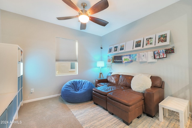 interior space with ceiling fan and light colored carpet