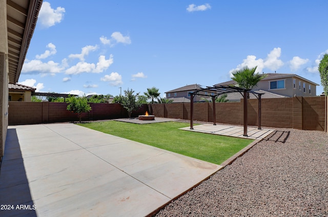 view of yard featuring an outdoor fire pit and a patio area