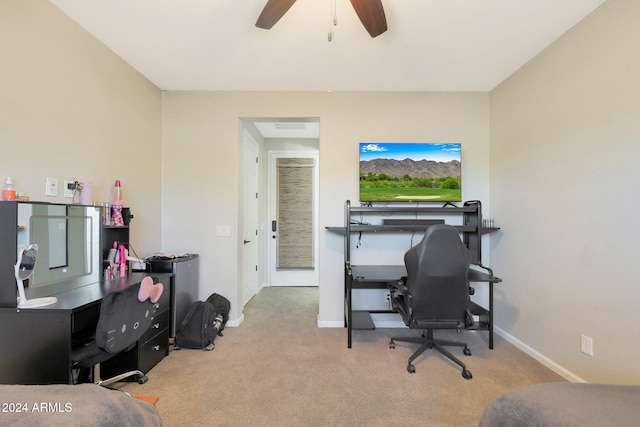 carpeted office space featuring ceiling fan