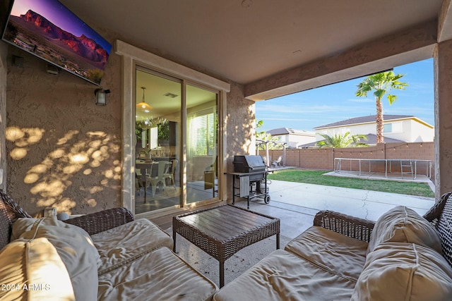 view of patio / terrace with area for grilling and a trampoline