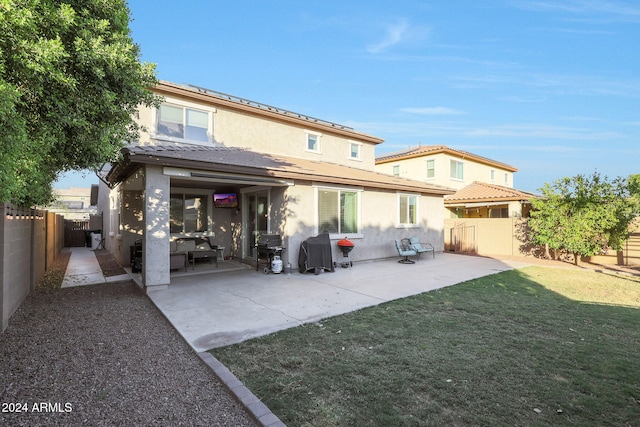 rear view of property with a patio and a yard